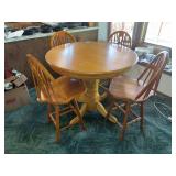 42 inch round oak table 35 inches tall with four swiveling wood stools