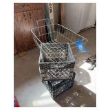 Two plastic milk crates and metal basket in garage