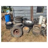 Misc stack of tires some with rims