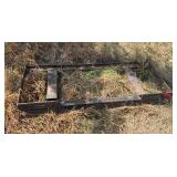 Universal skid steer to two bar conversion hookup for a skid loader