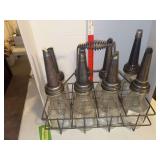 Oil bottles w wire carry case, bottles and spouts are marked