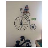 Bicycle and rubber doll, pillar candle holder