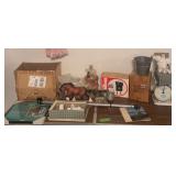 On top of table includes new wasp trap, baby scale, record holder, round mirrors, etc
