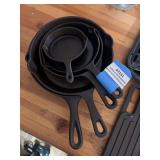 Five small cast-iron skillets