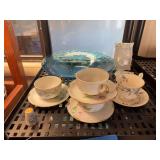 Cups and saucers and large blue decorative bowl and ceramic place mark tags
