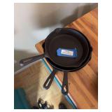 Three medium sized cast-iron skillets