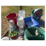 Assortment of feed pans, buckets, waterers, heat lamp