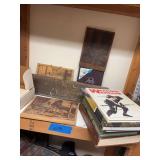 Pistol and gun related books with some wooden signs