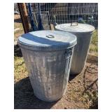 Two galvanized trash cans with lids