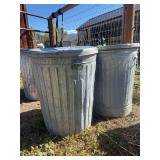 Two galvanized trash cans with lids