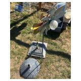 Two heavy umbrella bases and garden flower