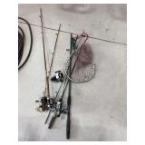Four fishing poles and reels, net