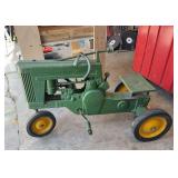John Deere 60? open engine compartment pedal tractor missing one front wheel and steering wheel is broken. As shown