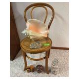 Large plastic seashell, jar of seashells, wood and ceramic pigs and cane seat chair