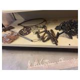 Miscellaneous cook stove parts, Cast leaf hangers, trivets