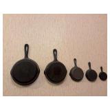 Collection of small cast iron Skillets, rug beaters, ladle, wall art piece