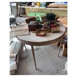 Table and all contents on top, old tins, money bags, water bag