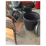 Four trash cans and three folding chairs. Trash cans have lids