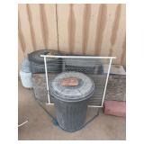 Propane bottles, trash cans, trash can with chains, corn in trash can
