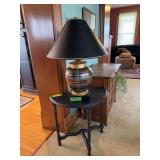 Black painted half moon table w Frederick Cooper table lamp with plaid pattern and brass accents