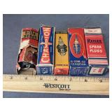 5 antique boxed spark plugs as shown