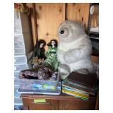 Large stuffed bear, Dr. Seuss and other children’s books, plus plastic container full of dolls, including two porcelain dolls with original tag
