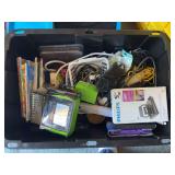 Large box of electronic type items and desk items, including coloring books, multiple small computers, various chords, etc.