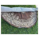 Large brown round rug with rubber mat