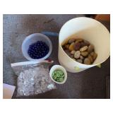 Assortment of decorative rocks, clear glass pieces, blue marbles, and green glass pieces