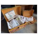 Two decorative storage totes with handy work and vintage linen
