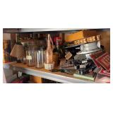 Shelf full of home decor, including signs and sayings, vases, lamps, jars