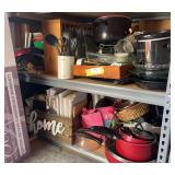 Two shelves full (contents only) of all kinds of kitchen items, including small appliances, cast-iron skillet, glass bakeware, Tupperware, cookbooks, coffee pots, pots and pans, dishes