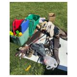 Miscellaneous outdoorsman items, including coats, lifejackets, water guns, fishing poles, hiking sticks, gun cases