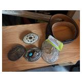 Four belt buckles, including Marlboro and turquoise with bear claw