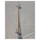 vintage multi-piece split bamboo fly fishing rod resting in a gray fabric storage sleeve.