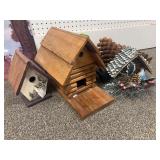 Three bird houses and large pinecones