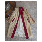 Vintage cream and red long coat featuring textured faux fur or wool-blend fabric with vibrant red trim, large contrasting buttons, embroidered details along the cuffs.