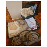 Box Containing a collection of vintage handmade cream-colored crocheted doilies and white fabric linens, Framed Flower Artwork, Bag of Curtains