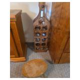Wine rack holds six bottles, tall, two bottles wide, short stool