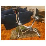 Weslo Pursuit E 25 Cross Cycle Upright Exercise Bike (also known as a Weslo dual-action air/cross cycle bike), featuring a green fan flywheel, white frame, black chain/belt cover, and moving handle ar