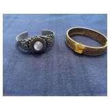 Two bracelets, gold colored one marked CT
