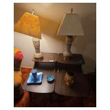 Two lamps, two tables with decorations