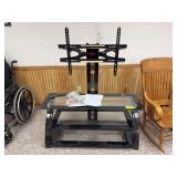 Glass tv stand w adjustable mounting bracket, fits up to 65” tv