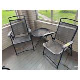 Two expanded metal folding chairs and side table