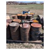 16 barrels most full of unknown content with hand pump