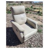 Small tan recliner w/ damage to footrest