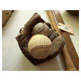 Antique baseballs, bats, football, baseball glove