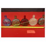 5 Wheaton full size bottles, blue, 2 green, ruby