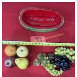Half a watermelon with plastic fruit