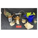 Box of watering cans, seashells, decorative items